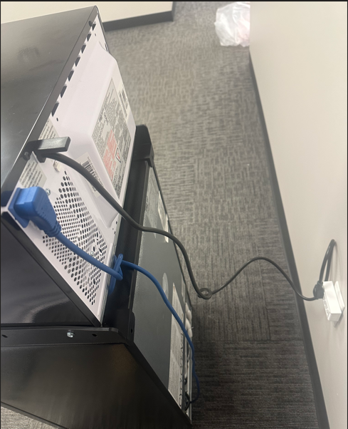 A computer tower with wires plugged into the wall

AI-generated content may be incorrect.